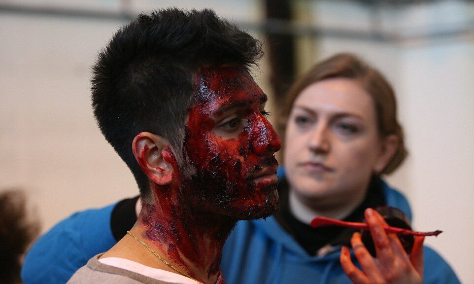 model having dmake up applied to simulate facial injuries