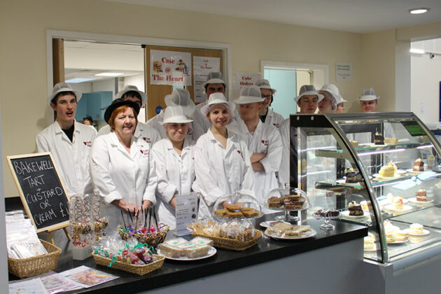 Students stand in their cafe which has earned a 5 star hygiene rating.