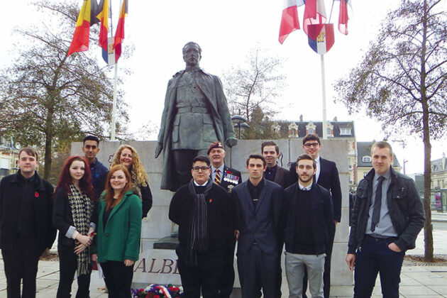 Students stand in front of the memorial.
