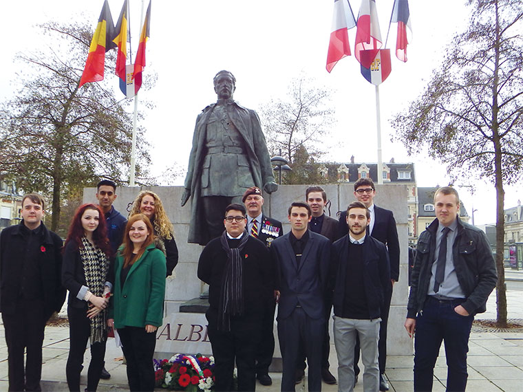 Students stand in front of the memorial.