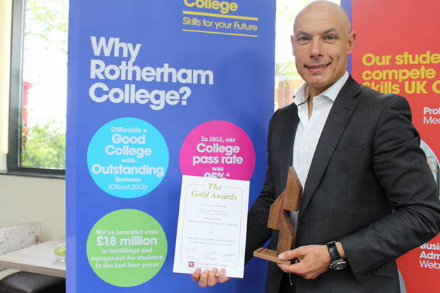 Howard Webb stands with his award.