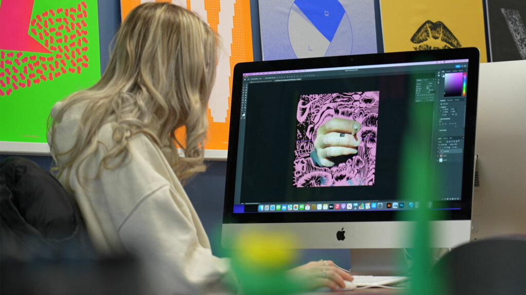 A student working in the Graphic Design Studio