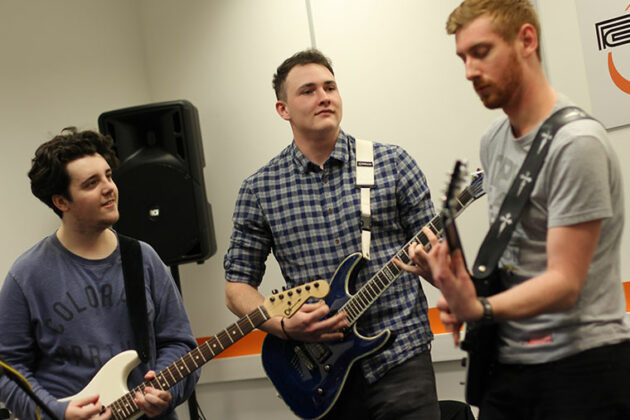 Students playing guitars