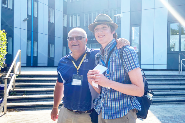 Award winning Creative Media Production student Blake Morley stood with their tutor outside Rotherham College.