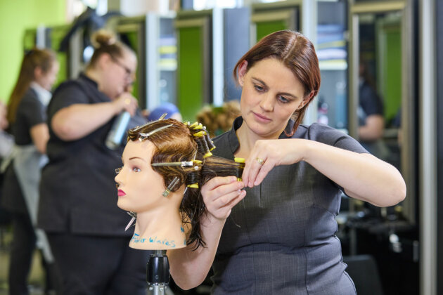 A hairdressing student in the Inspire Salon