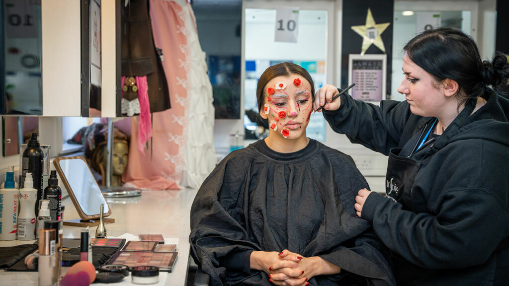 A media make up student working on a client