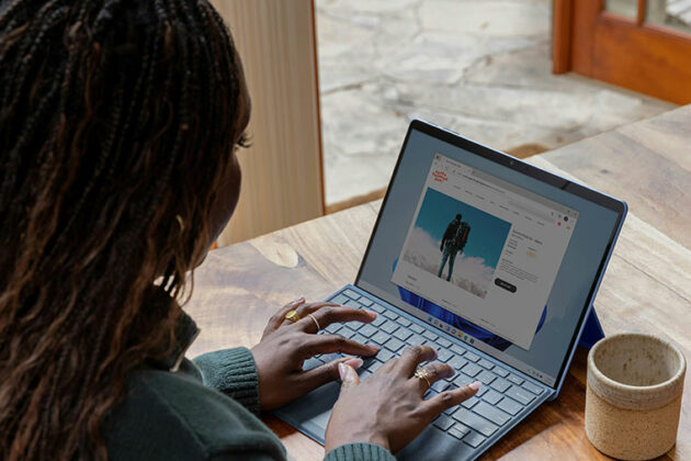 Someone sat at a desk working on a laptop at home