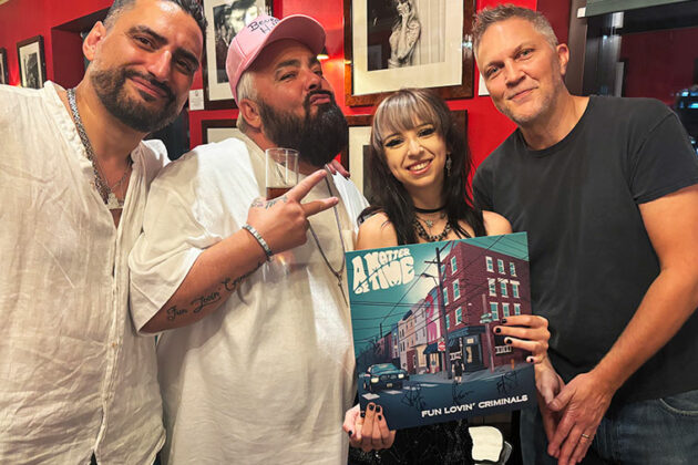 Graphic designer Macy Beddows with Fun Lovin' Criminals (from left) Naim Cortazzi, Frank Benbini and Brian Leiser at the "A Matter of Time" album launch party at Canary Wharf in London